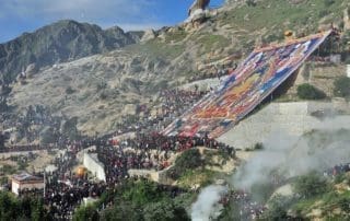 It traditionally began with the unveiling of large Thangka paintings, which are intricate and colorful depictions of Buddhist deities, scenes, and stories. These Thangkas are unfurled on the sides of hills or monastery walls, and the faithful come to make offerings and receive blessings.